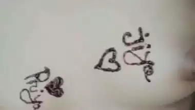 Nude girl puts henna on her naked body during a video call sex