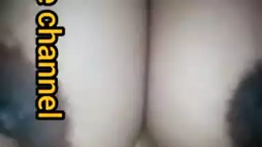 Naughty Desi woman squeezes tits to lick nipples in the porn video