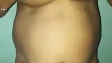 Desi woman with sexy fat tummy and big tits spreads pussy in XXX video